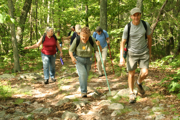 Lester leading a hike for a group of people