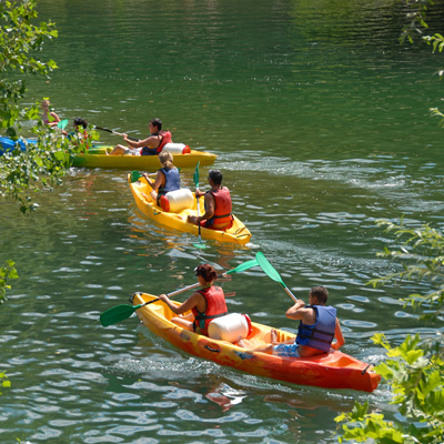 a group of people canoeing
