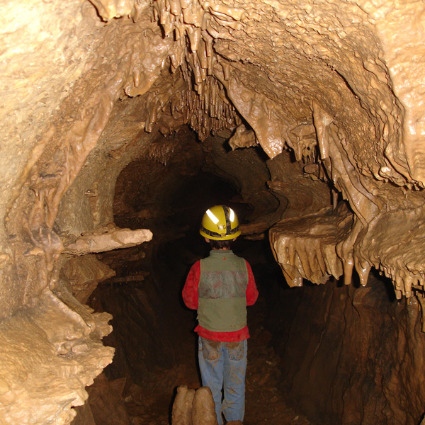 young boy exploring a cave