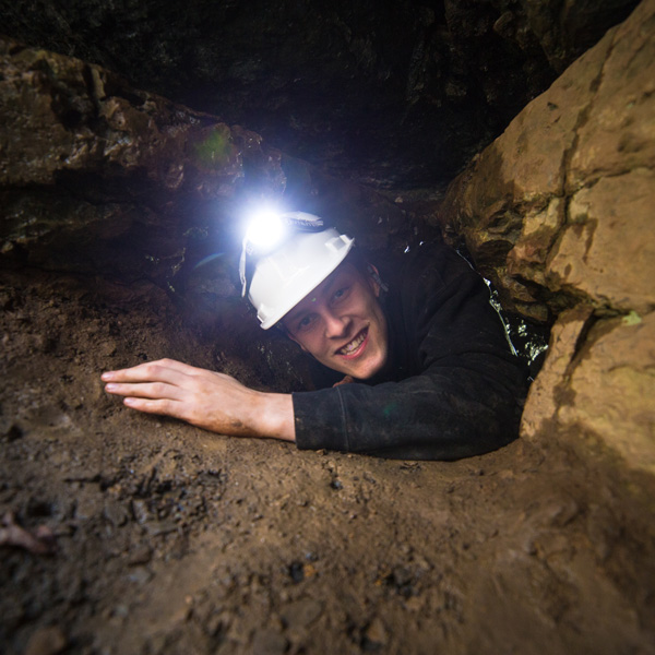 man exploring a cave