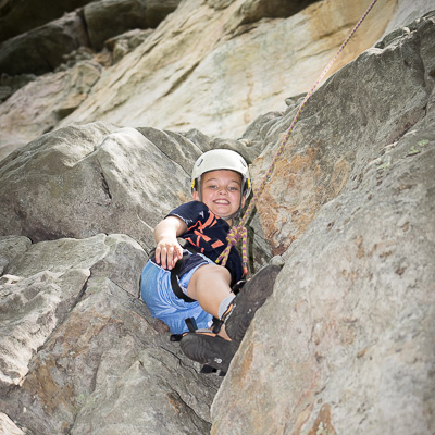 boy rock climbing