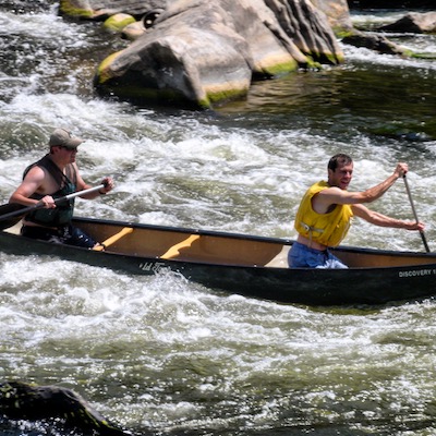 two men canoeing with wild guyde